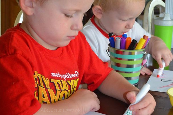 Two boys coloring with markers.