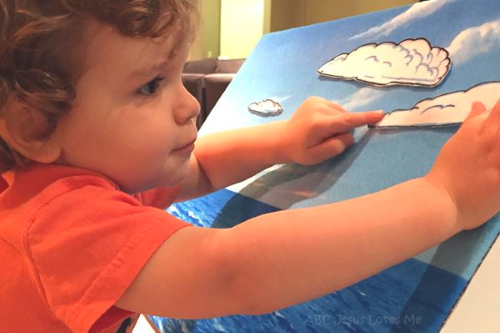 Child playing with Bible flannelgraph.