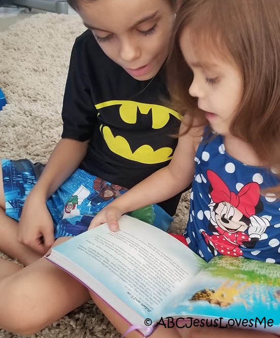 Children reading the Bible together.