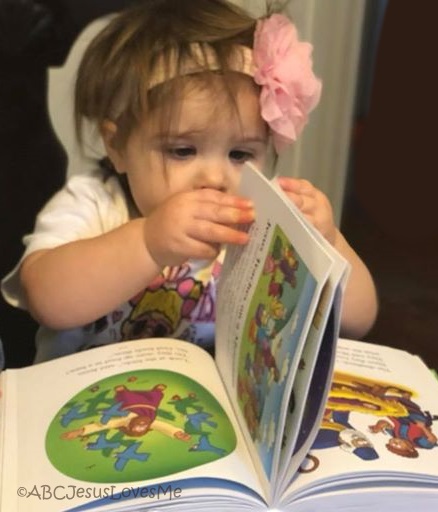 Child reading a children's Bible