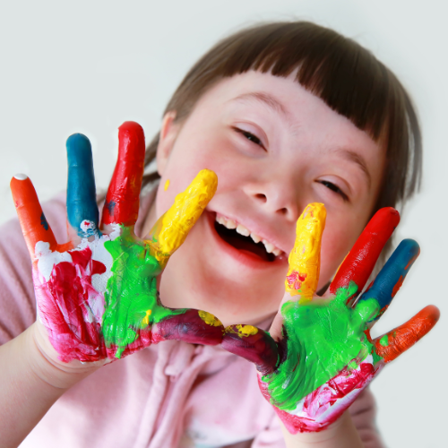 Child with paints hands to make handprints.