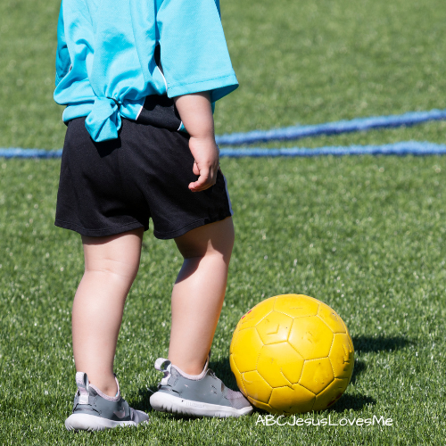 Child kicking a soccer ball.