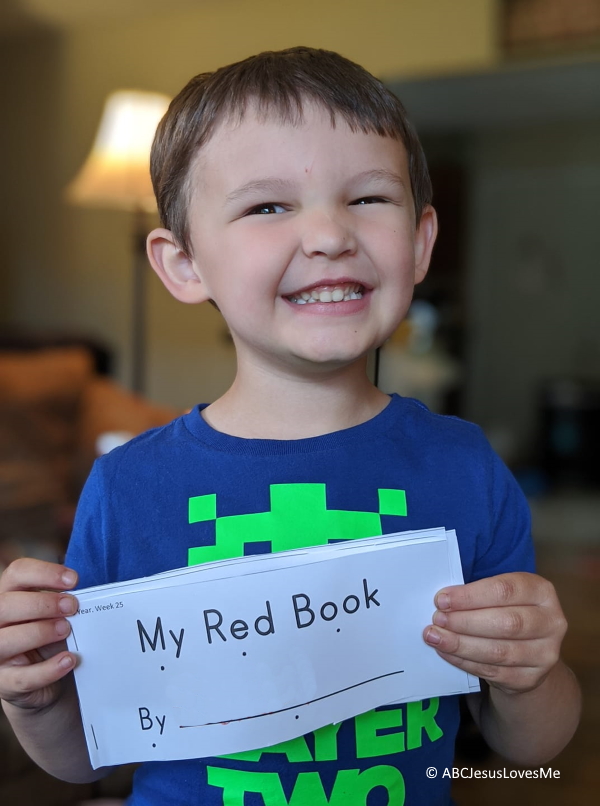 Little boy holding a book.