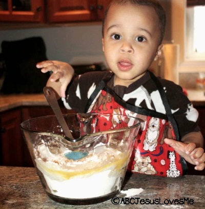 Preschool boy cooking.