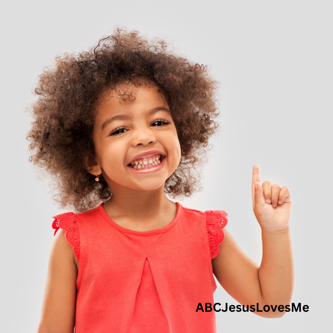 Child smiling and doing a fingerplay.