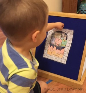 Child playing with Bible flannelgraph.