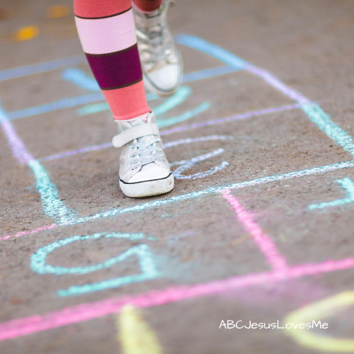 Child jumping hopscotch.