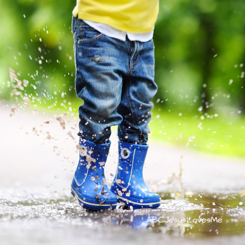 Child jumping in a puddle