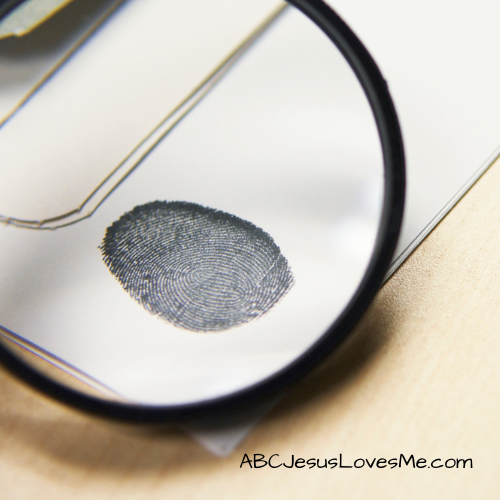 Magnifying glass looking at a fingerprint.