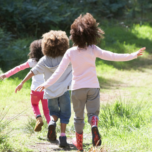 Children playing follow the leader outside.