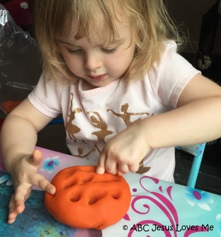 Child playing with play dough