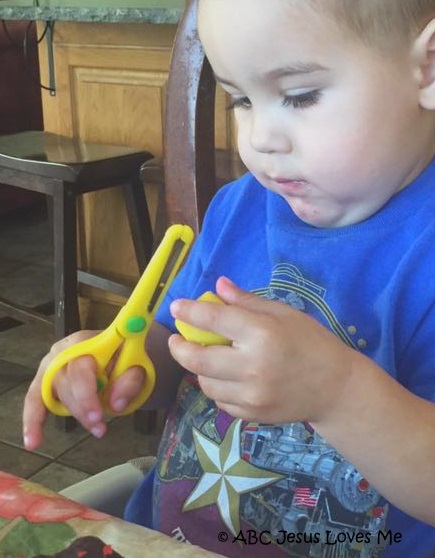Preschool boy using scissors