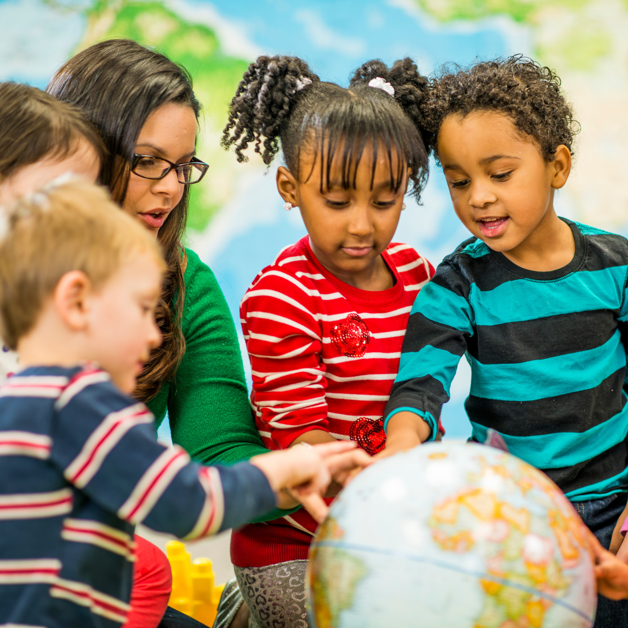 Children standing around a globe
