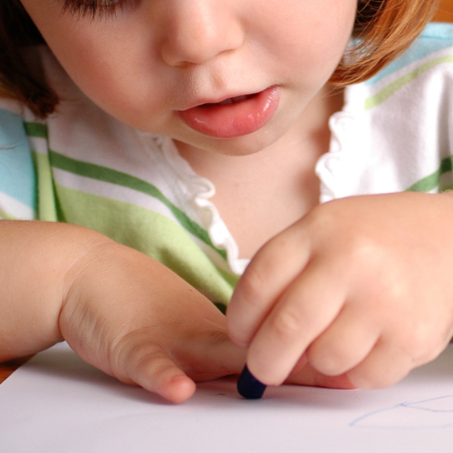 Tracing a child's hands with a pencil.